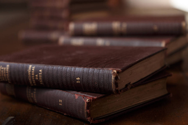 Old books on rustic wooden table. Stack of books. Background blurred. Scenery rustic, brown and warm. - Photo, Image