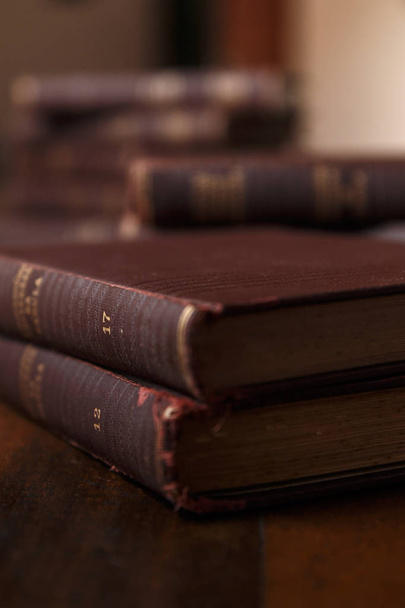 Old books on rustic wooden table. Stack of books. Background blurred. Scenery rustic, brown and warm. - Photo, Image