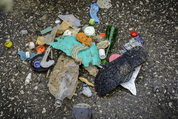 Πλαστικό στην παραλία με σύριγγα και άλλα πλαστικά σκουπίδια. - Φωτογραφία, εικόνα