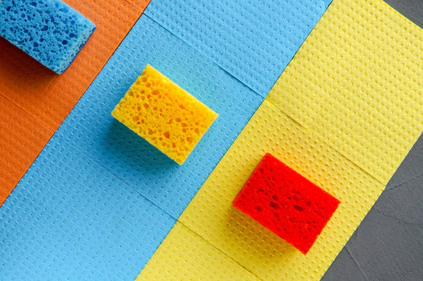 Cleaning day concept, colorful sponges over gray concrete background - Fotó, kép