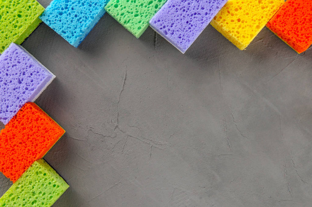 Cleaning day concept, colorful sponges over gray concrete background, copy space, empty text - 写真・画像
