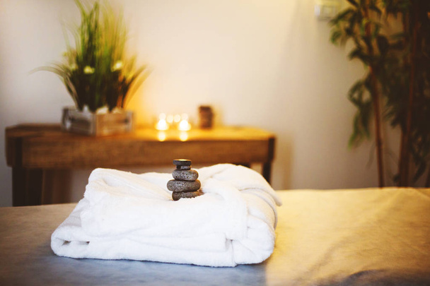 White bathrobe on the bed in the spa salon - Foto, imagen