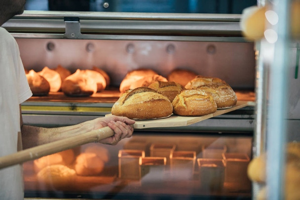 Baker making bread at a bakery. Bakery Concept. - Foto, Imagen