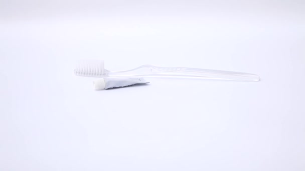 Hand squeezing toothpaste onto the toothbrush - Footage, Video