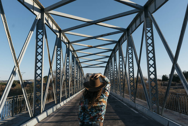  Beautiful girl having fun in the iron bridge - Photo, Image