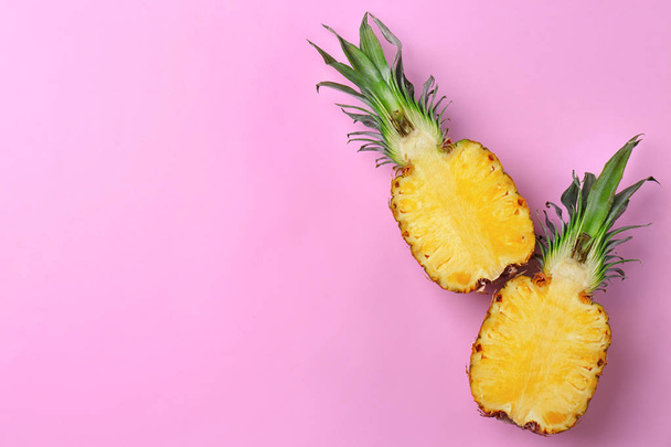 Fresh pineapple halves on color background - Valokuva, kuva