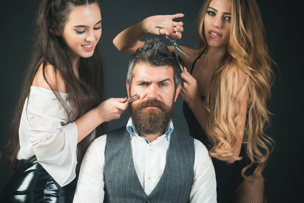 Women, girls with comb, scissors cut hair. girls or women make haircut for man - Photo, image