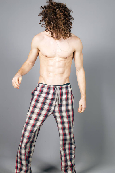 Young athletic ginger in pyjamas man studio portrait - Foto, imagen