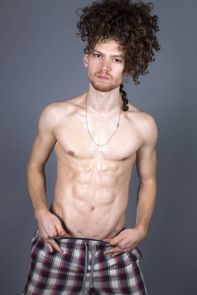 Young athletic ginger in pyjamas man studio portrait - Foto, immagini