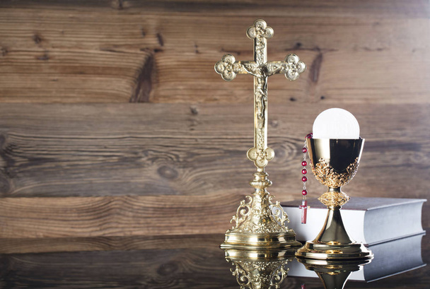 Holy communion concept. The Cross, Holy Bible, rosary and golden chalice. - Photo, Image