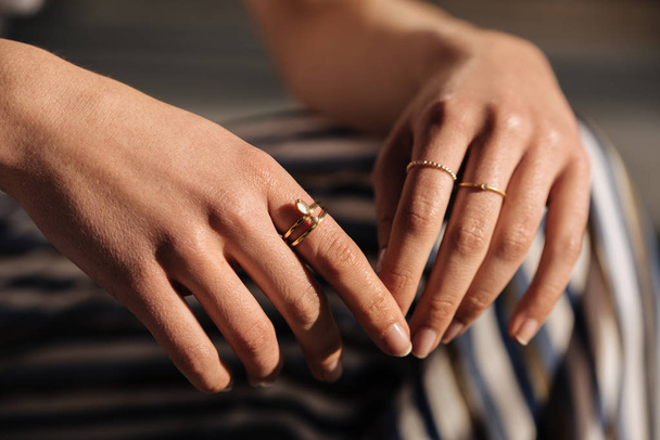 Crop woman hands with rings on the street - Фото, зображення
