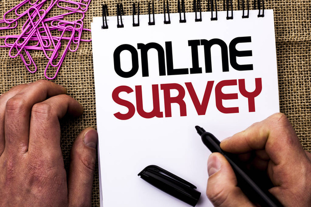 Text sign showing Online Survey. Conceptual photo Digital Media Poll Customer Feedback Opinions Questionnaire written by Man Holding Marker on Notebook Book on the jute background Pins next to it - Fotó, kép