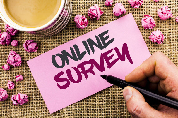 Conceptual hand writing showing Online Survey. Business photo text Digital Media Poll Customer Feedback Opinions Questionnaire written by Man Holding Marker on Paper on the jute background Cup - Photo, Image