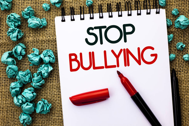 Writing note showing  Stop Bullying. Business photo showcasing Do not continue Abuse Harassment Aggression Assault Scaring written on Notebook Book on the jute background Markers next to it. - Photo, Image