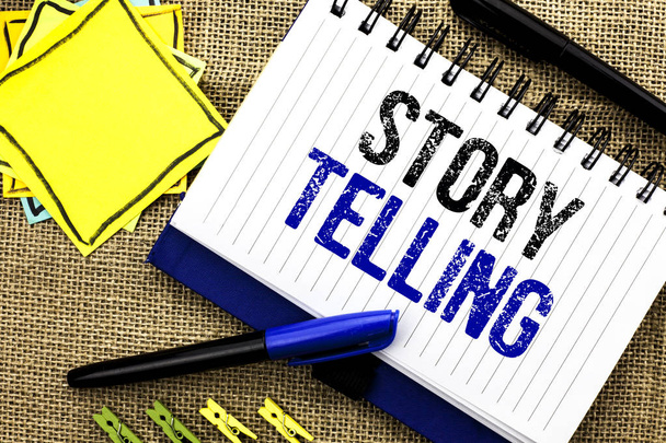Conceptual hand writing showing Story Telling. Business photo showcasing Tell or write short Stories Share Personal Experiences written on Notebook Book on the jute background Clips and Pens - Photo, Image