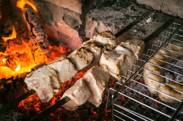 Barbecue meat steaks on the grill with flames. Meat on the coals. barbecue vacation concept close up. - Foto, imagen