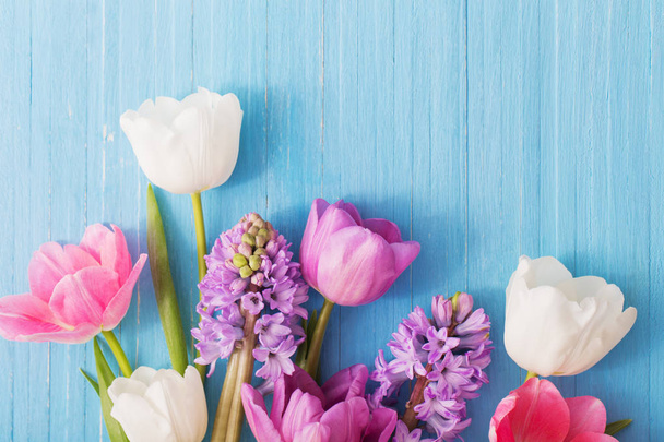 beautiful spring flowers on blue wooden background - Zdjęcie, obraz