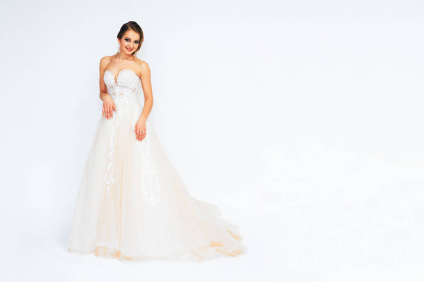 beautiful young bride in a wedding dress demonstrates different poses - Zdjęcie, obraz