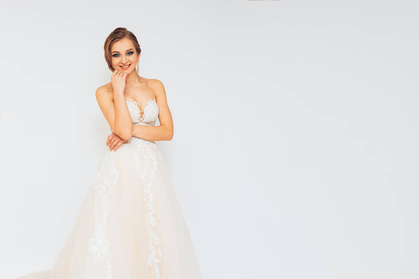beautiful young bride in a wedding dress demonstrates different poses - Φωτογραφία, εικόνα