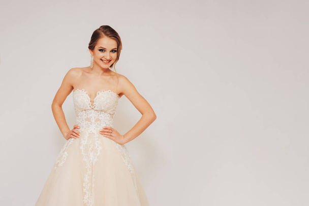 beautiful young bride in a wedding dress demonstrates different poses - Photo, image