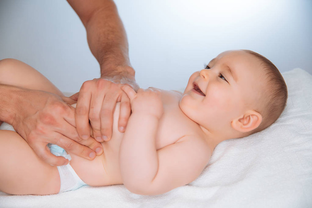 Doctor massaging a cute baby - Photo, Image
