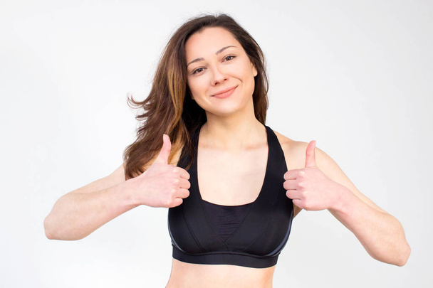 Fit woman in sport bra  , young woman with thumbs up. not isolated - Φωτογραφία, εικόνα
