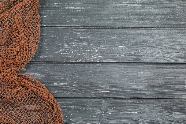 Wooden background with old fishing net - Foto, Bild