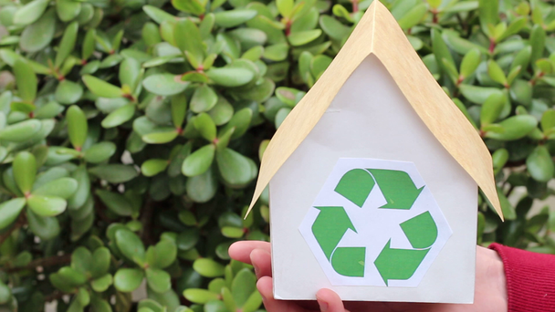 Ruce držel dům se zeleným recyklace Sign. Lidé, ekologie, životní prostředí a ochranu koncept - Detailní záběr rukou držel dům se zeleným recyklační znak - Záběry, video