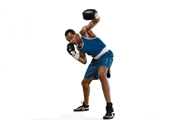 Sporty man during boxing exercise making hit. Photo of boxer on white background - Foto, Imagem