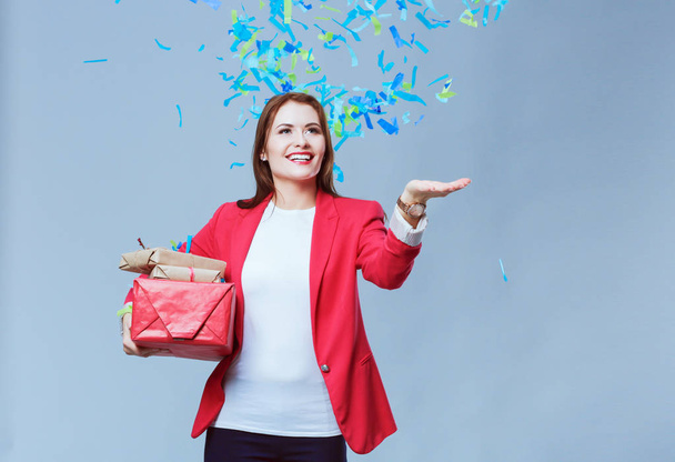Beautiful happy woman with gift box at celebration party with confetti . Birthday or New Year eve celebrating concept - Foto, afbeelding