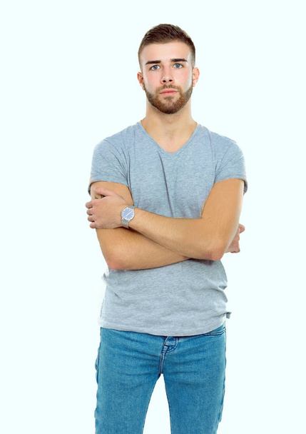 Portrait of a happy casual man standing isolated on a dark background - Photo, image