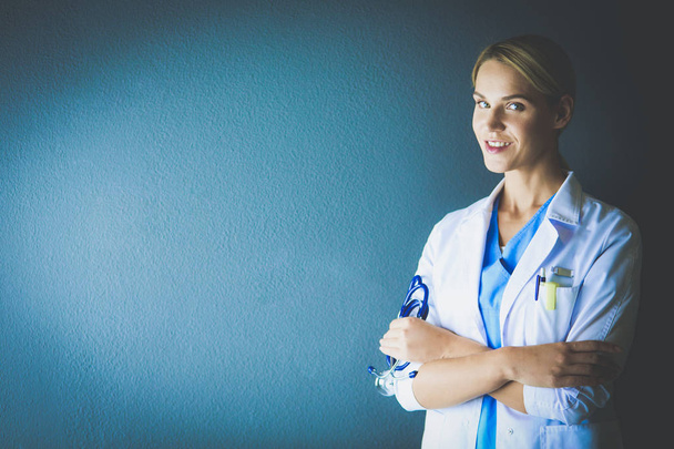 Portrait of young woman doctor with white coat standing in hospital. - Fotografie, Obrázek