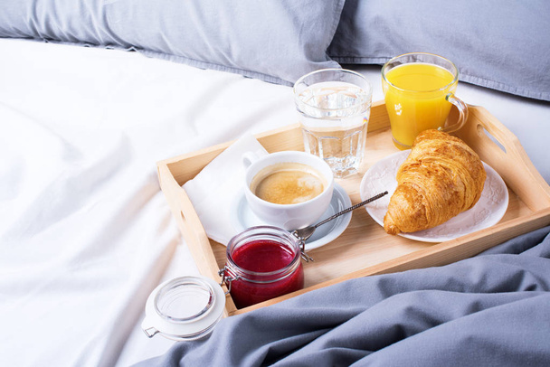 morning breakfast bed wooden tray coffee croissant - Фото, изображение