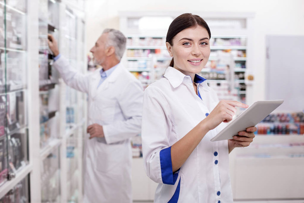 Charming female pharmacist developing electronic system - Foto, immagini