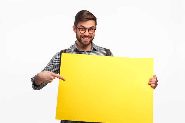 Smiling man with yellow banner - 写真・画像