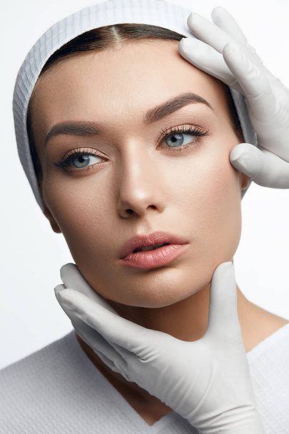 Plastic Surgery. Hands Touching Beautiful Woman Face - Fotoğraf, Görsel