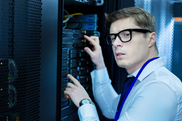 Serious operator working in a data center - Foto, Imagen