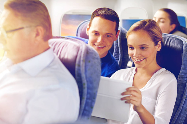 happy passengers with coffee talking in plane - Φωτογραφία, εικόνα
