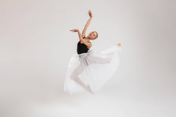 Pretty young woman ballerina dancing gracefully - Photo, Image