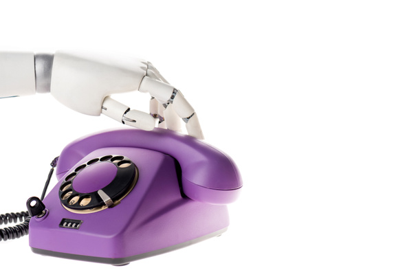 Робот руки касаясь ультрафиолетового ретро стационарного телефона изолированы на белом
 - Фото, изображение