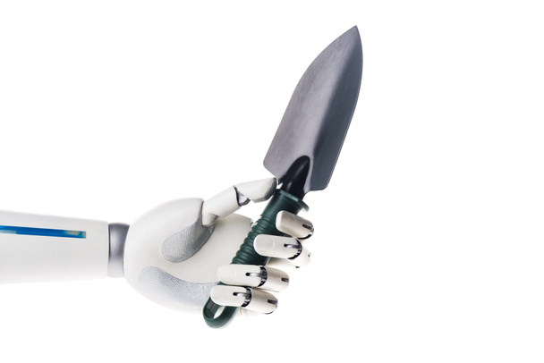 robot hand holding garden shovel isolated on white - Foto, afbeelding