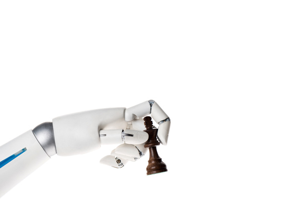robot hand holding chess king figure isolated on white - Valokuva, kuva