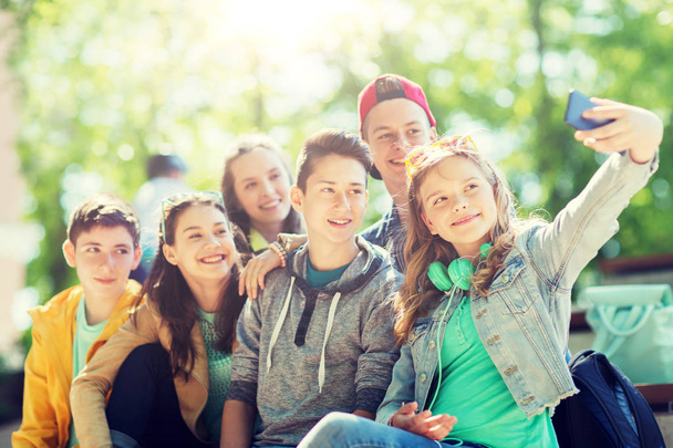 happy teenage students taking selfie by smartphone - Foto, Imagem