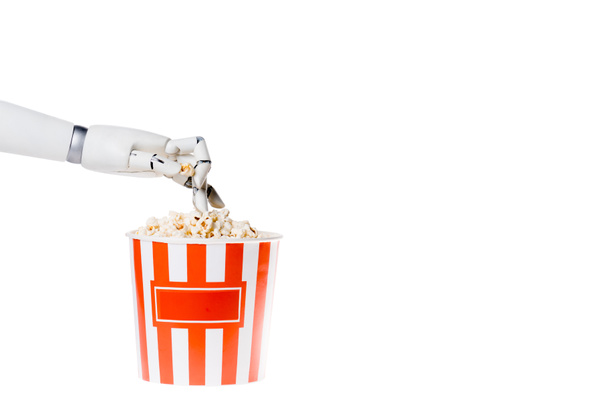 cropped shot of robot taking popcorn out of bucket isolated on white - Photo, image