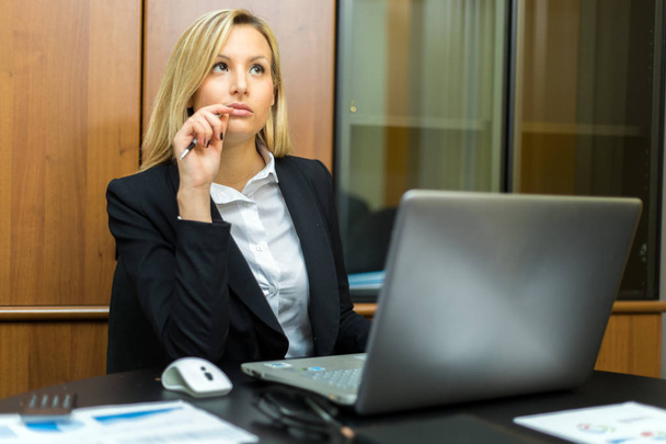 Businesswoman at work thinking  - Фото, зображення