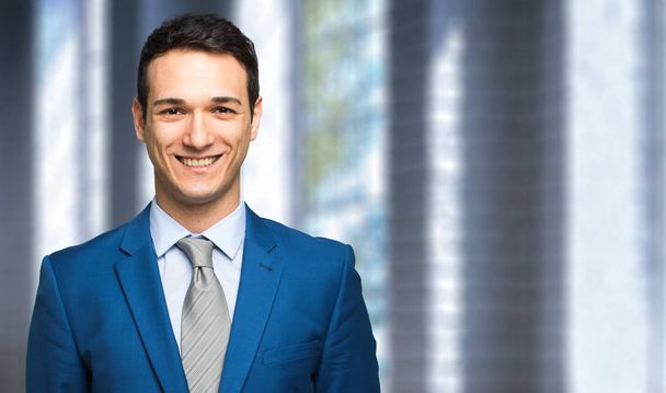 Portrait of businessman smiling in the office - Foto, Imagem