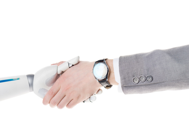 cropped shot of robot and businessman shaking hands isolated on white - 写真・画像