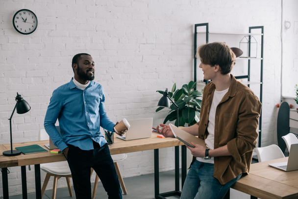 stilvolle multiethnische Geschäftspartner im Gespräch im modernen Büro  - Foto, Bild