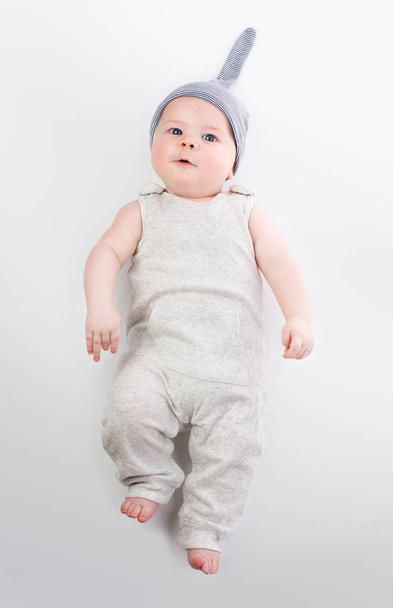 Baby in hat and overalls on white background - Fotografie, Obrázek