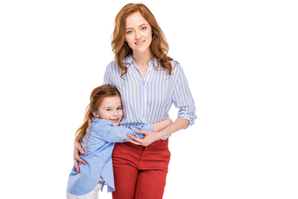 beautiful happy mother and daughter hugging and smiling at camera isolated on white - Foto, Imagen